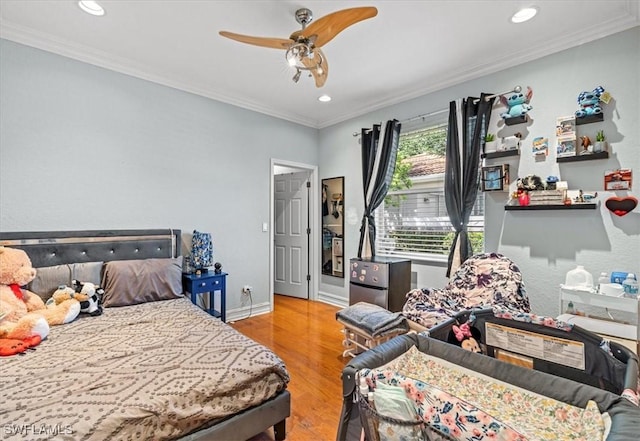 bedroom with ceiling fan, ornamental molding, and light wood-type flooring