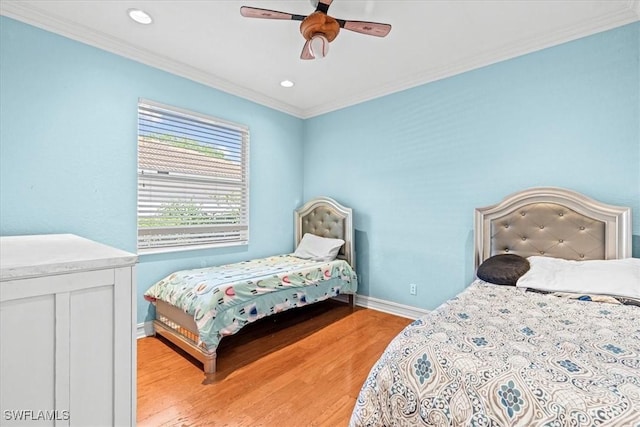 bedroom featuring ceiling fan, light hardwood / wood-style floors, and ornamental molding