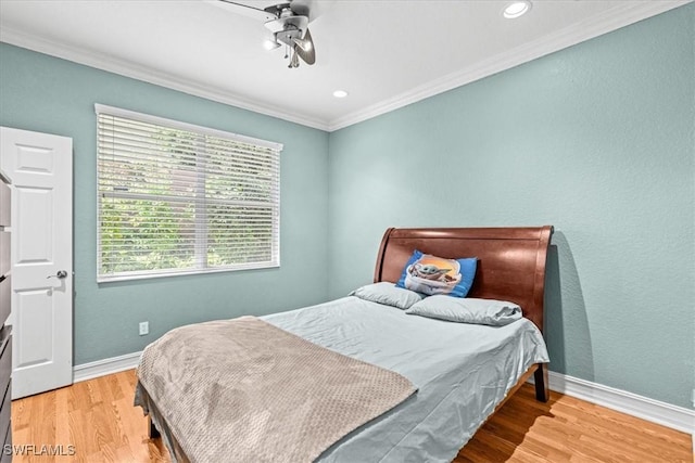 bedroom featuring ceiling fan, crown molding, and wood-type flooring