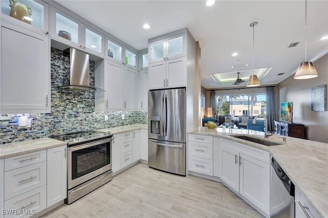 kitchen featuring white cabinets, wall chimney exhaust hood, sink, and stainless steel appliances