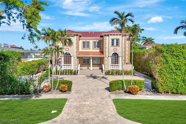 mediterranean / spanish house with a front yard