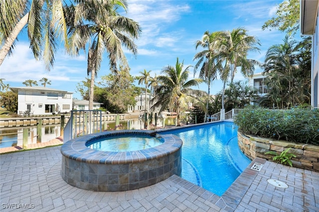 view of swimming pool with a patio area, a community hot tub, and a water view