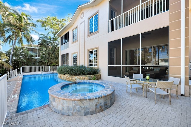 view of pool featuring a patio area and an in ground hot tub