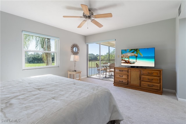 carpeted bedroom featuring multiple windows, access to outside, and ceiling fan