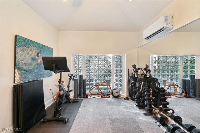 workout area with a wall mounted air conditioner and baseboards