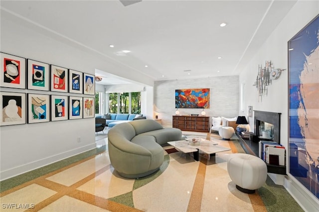 living room featuring a fireplace, baseboards, and recessed lighting