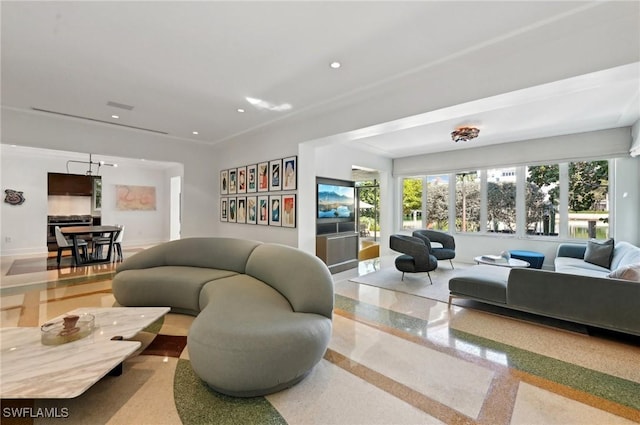 living area with recessed lighting, a healthy amount of sunlight, baseboards, and speckled floor