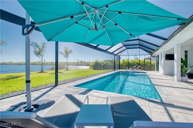 view of swimming pool featuring a yard, a water view, a lanai, and a patio area