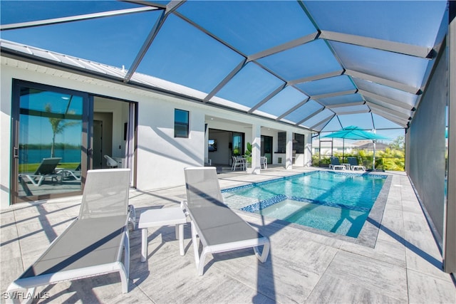 view of pool with an in ground hot tub, glass enclosure, and a patio area