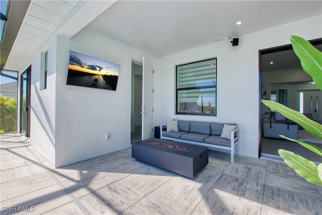 view of patio / terrace with an outdoor living space with a fire pit