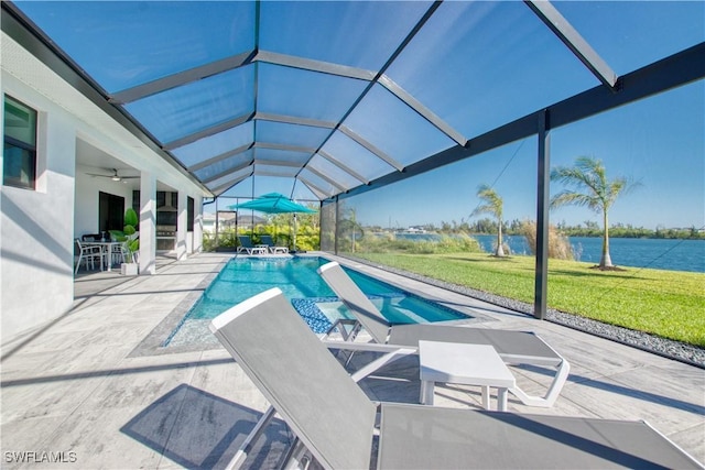 view of swimming pool with a lanai, a water view, ceiling fan, and a patio area