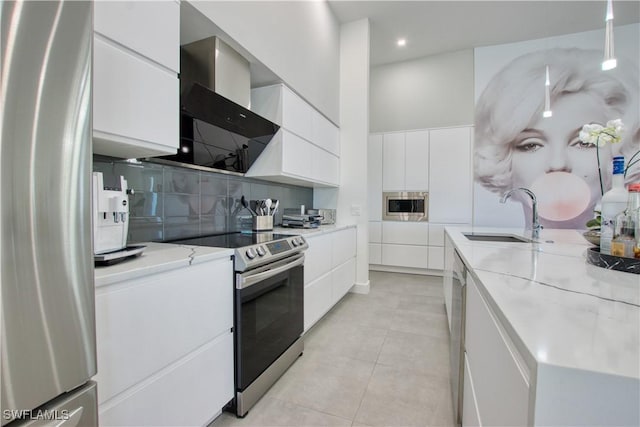 kitchen with sink, stainless steel appliances, white cabinetry, and light stone counters