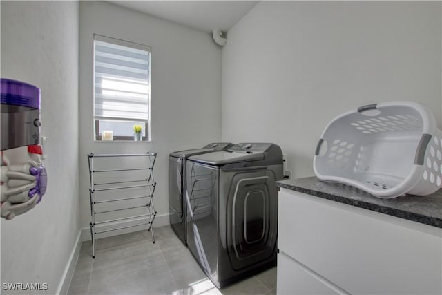 laundry area featuring light tile patterned flooring and separate washer and dryer