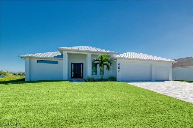 view of front of house featuring a garage and a front lawn