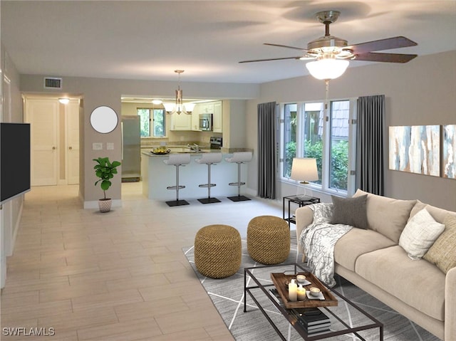 living room with ceiling fan with notable chandelier