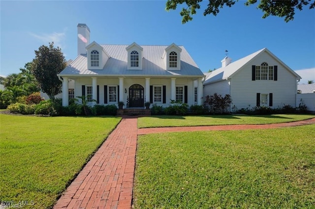 new england style home featuring a front lawn