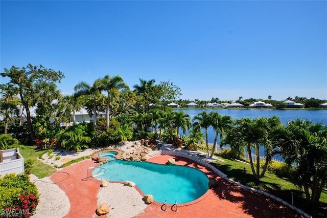 view of swimming pool with a water view and a patio