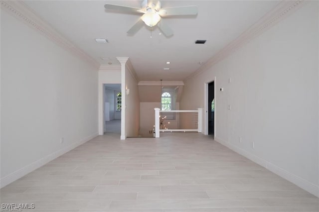 spare room featuring ceiling fan and crown molding