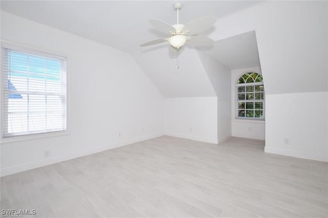 additional living space with ceiling fan, light hardwood / wood-style flooring, and vaulted ceiling