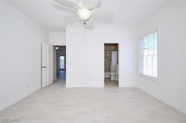 unfurnished bedroom with ensuite bathroom, ceiling fan, and light hardwood / wood-style flooring