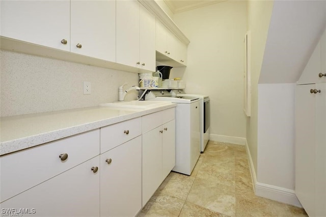 laundry area featuring cabinets, independent washer and dryer, and sink