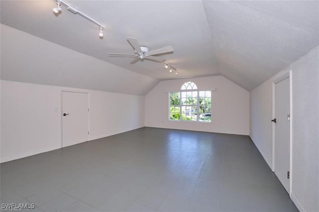 bonus room featuring a textured ceiling, ceiling fan, and vaulted ceiling