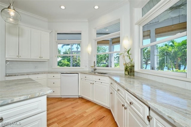 kitchen featuring dishwasher, white cabinets, light wood-type flooring, and sink