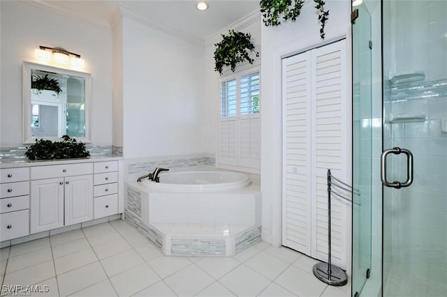 bathroom featuring tile patterned flooring, vanity, shower with separate bathtub, and crown molding