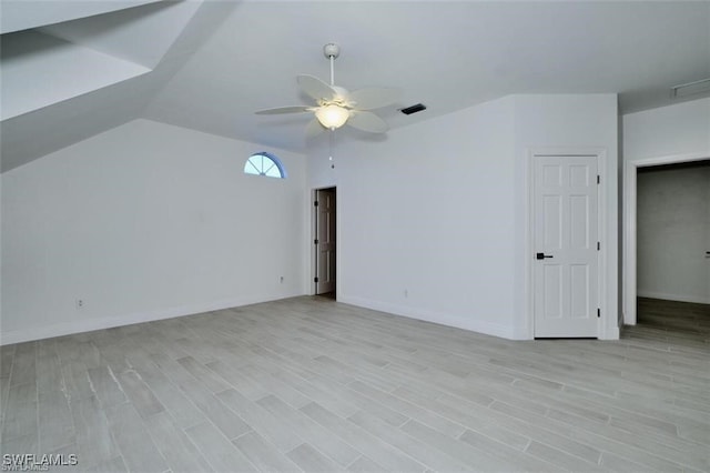 unfurnished room with light wood-type flooring, ceiling fan, and lofted ceiling