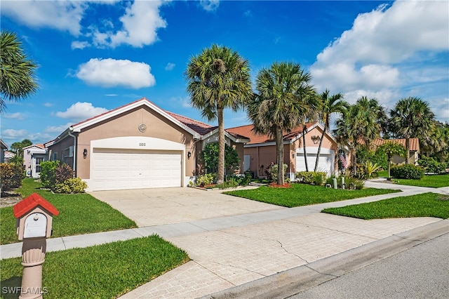 view of front of property with a front lawn and a garage