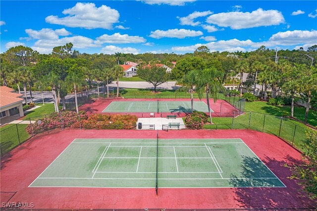 view of sport court featuring a yard and basketball hoop