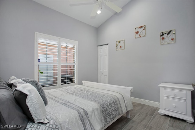 bedroom with a closet, vaulted ceiling, and ceiling fan