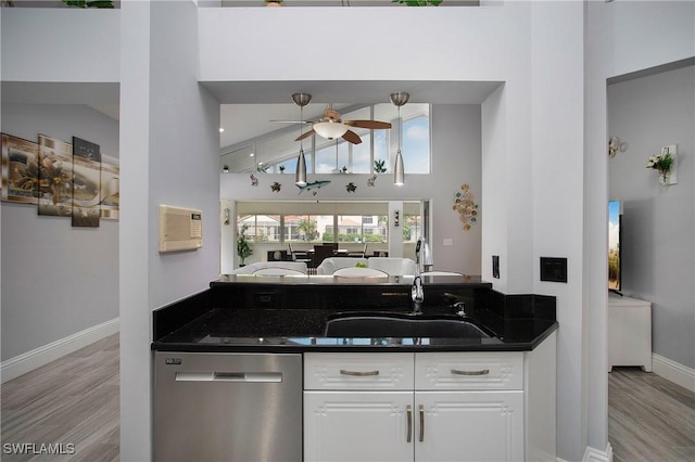 159 Lady Palm Dr, Naples, FL 34104 - kitchen with dishwasher, ceiling fan, light wood-type flooring, white cabinetry, and high vaulted ceiling