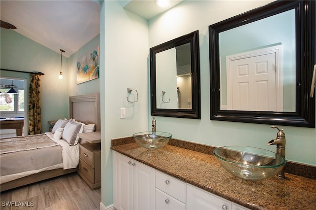 bathroom with vanity and lofted ceiling