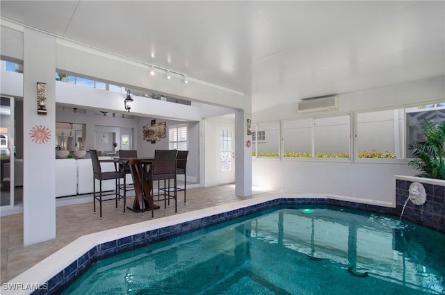 view of pool featuring a wall mounted air conditioner