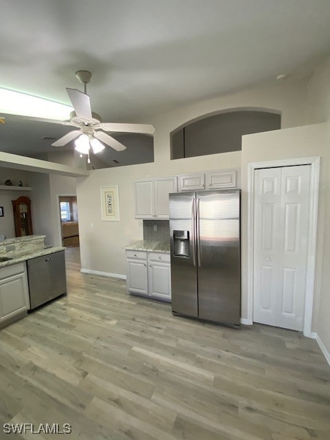 kitchen featuring ceiling fan, white cabinets, light wood-type flooring, and appliances with stainless steel finishes