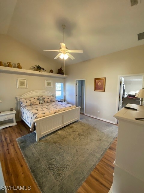 bedroom with ceiling fan, dark hardwood / wood-style flooring, and lofted ceiling