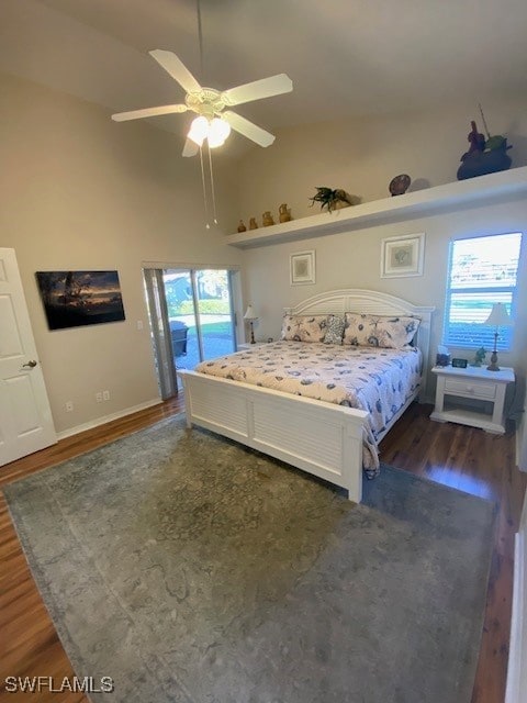 bedroom featuring dark hardwood / wood-style flooring, access to outside, high vaulted ceiling, and ceiling fan