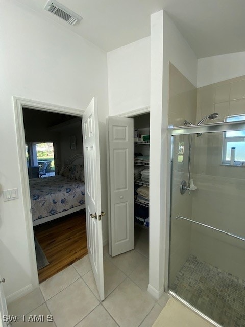 bathroom with tile patterned floors and an enclosed shower