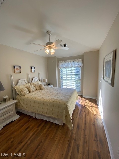 bedroom featuring dark hardwood / wood-style flooring, ceiling fan, and lofted ceiling