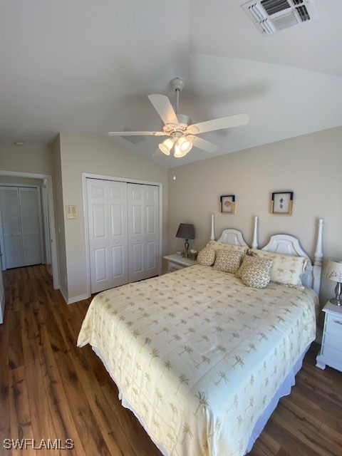 bedroom featuring dark hardwood / wood-style flooring, a closet, vaulted ceiling, and ceiling fan