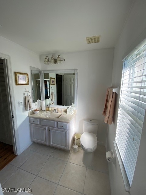 bathroom with tile patterned floors, vanity, and toilet