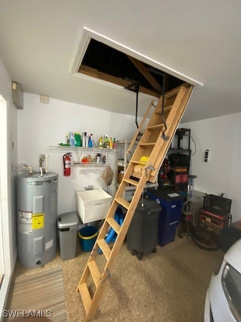 interior space with electric water heater and sink