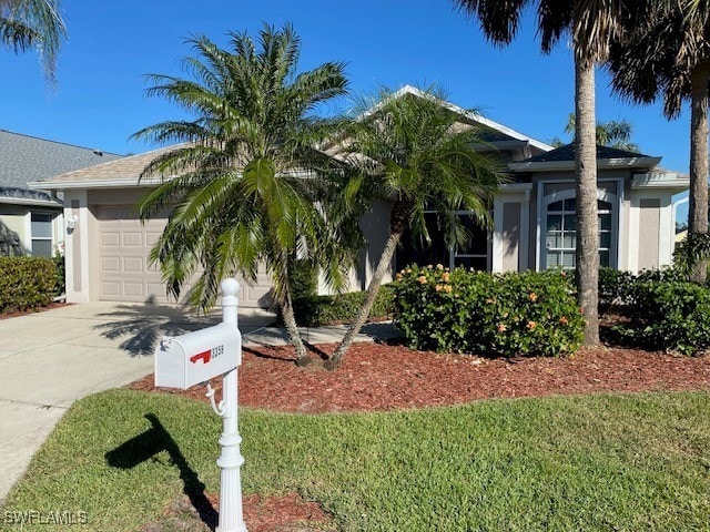 view of front of house with a front yard and a garage