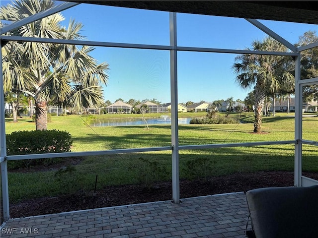 unfurnished sunroom featuring a water view