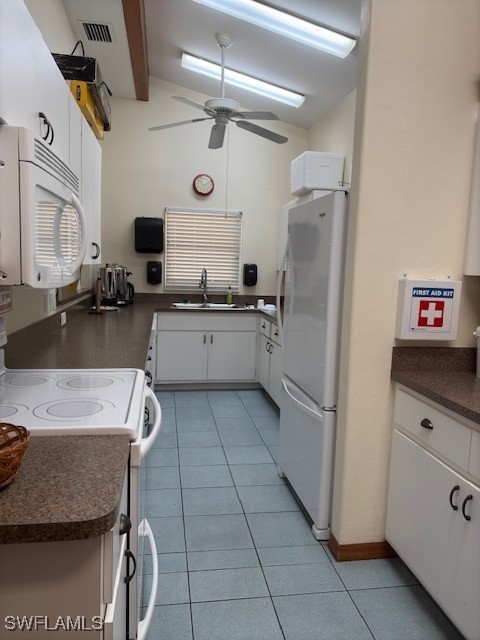 kitchen with white cabinetry, sink, ceiling fan, lofted ceiling with beams, and white appliances