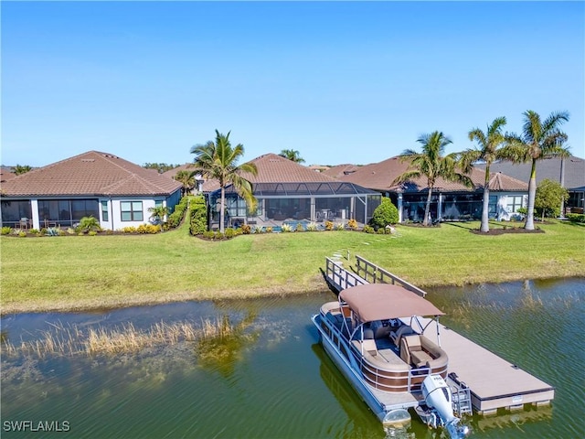 view of dock with a lawn, glass enclosure, and a water view