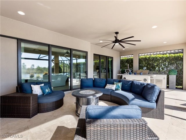 view of patio with ceiling fan, exterior kitchen, and an outdoor hangout area