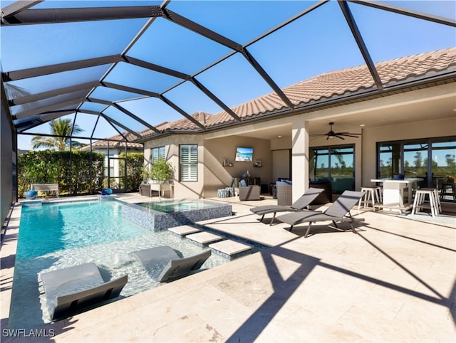 view of pool featuring a lanai, ceiling fan, a patio area, and an in ground hot tub