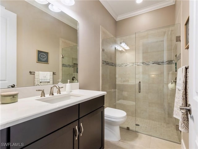 bathroom with tile patterned floors, crown molding, toilet, a shower with door, and vanity